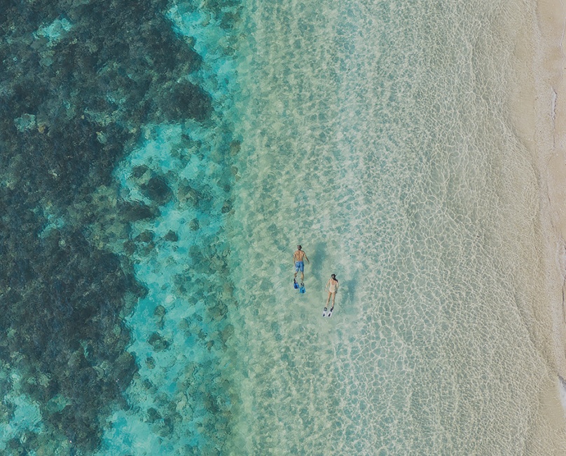 couple snorkeling in the blue ocean of Con Dao