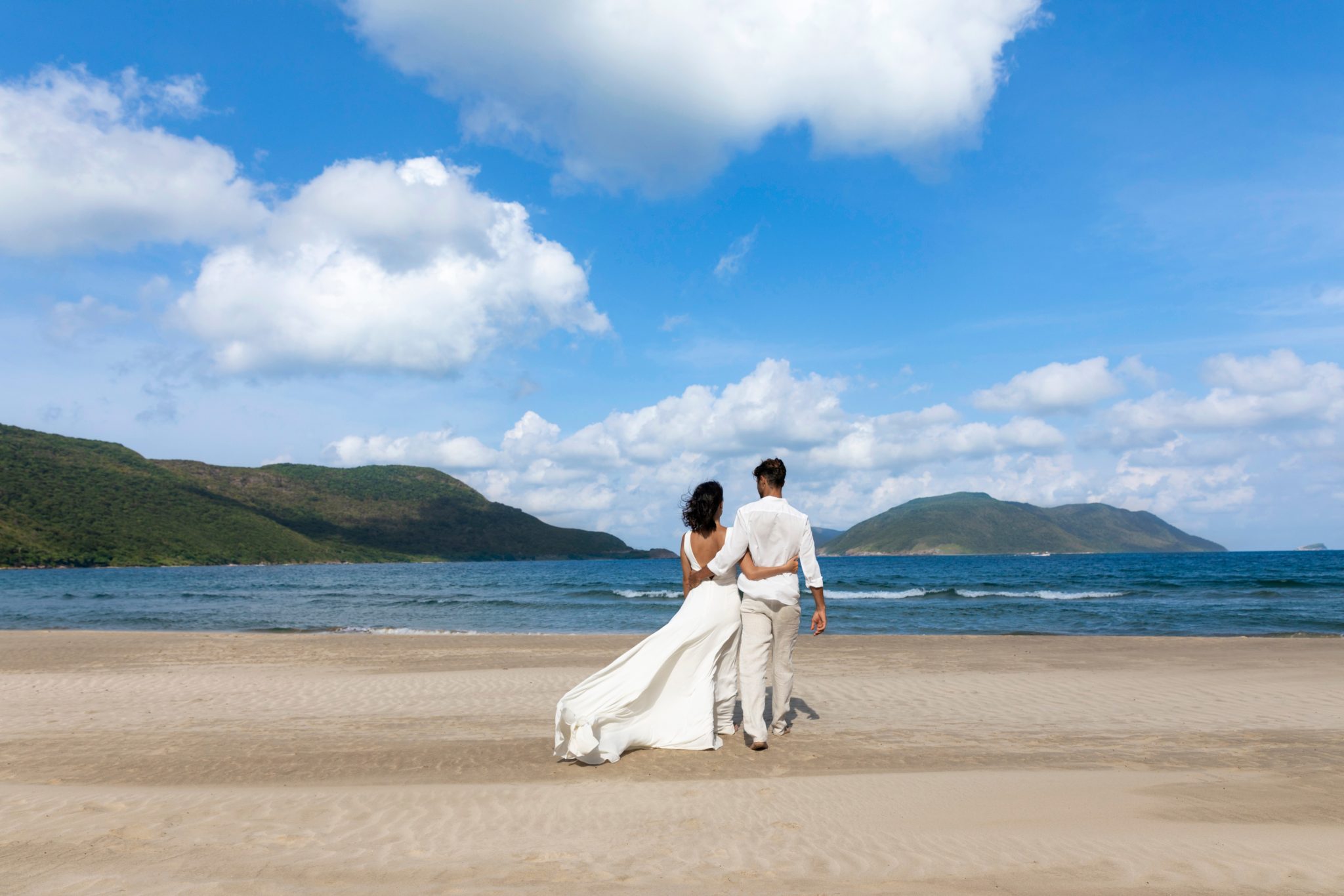 married couple standing on the beach of Six Senses Con Dao