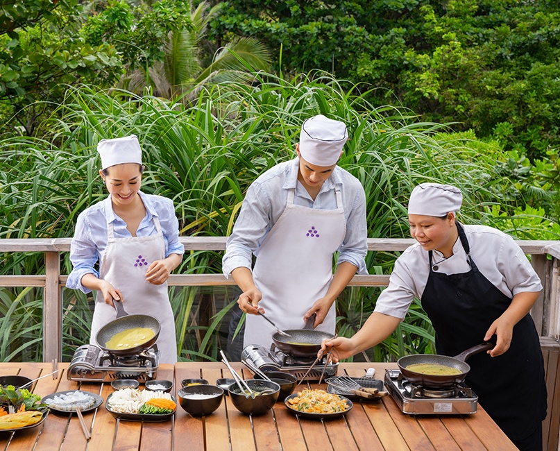 Couple learning to cook at Six Senses Con Dao