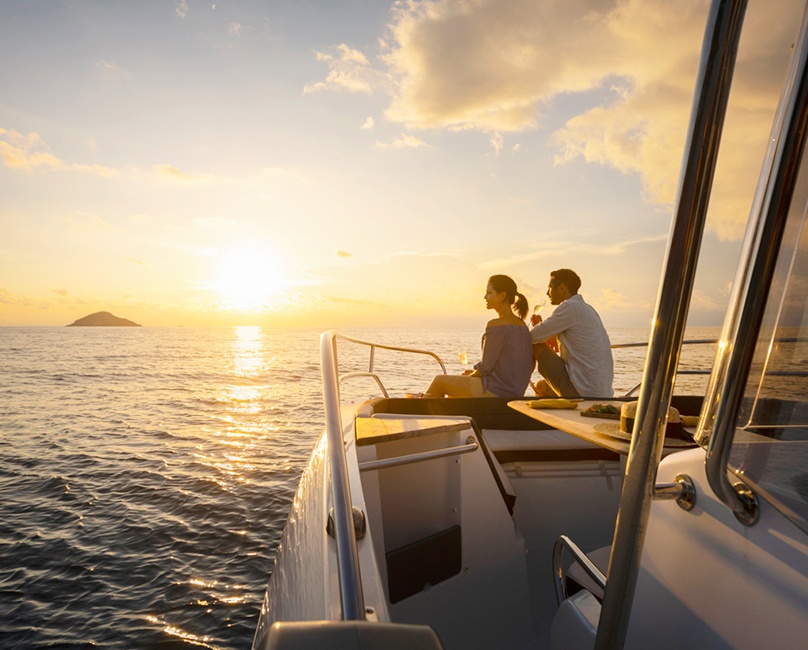Couple watching the sunset on a speedboat at Six Senses Con Dao