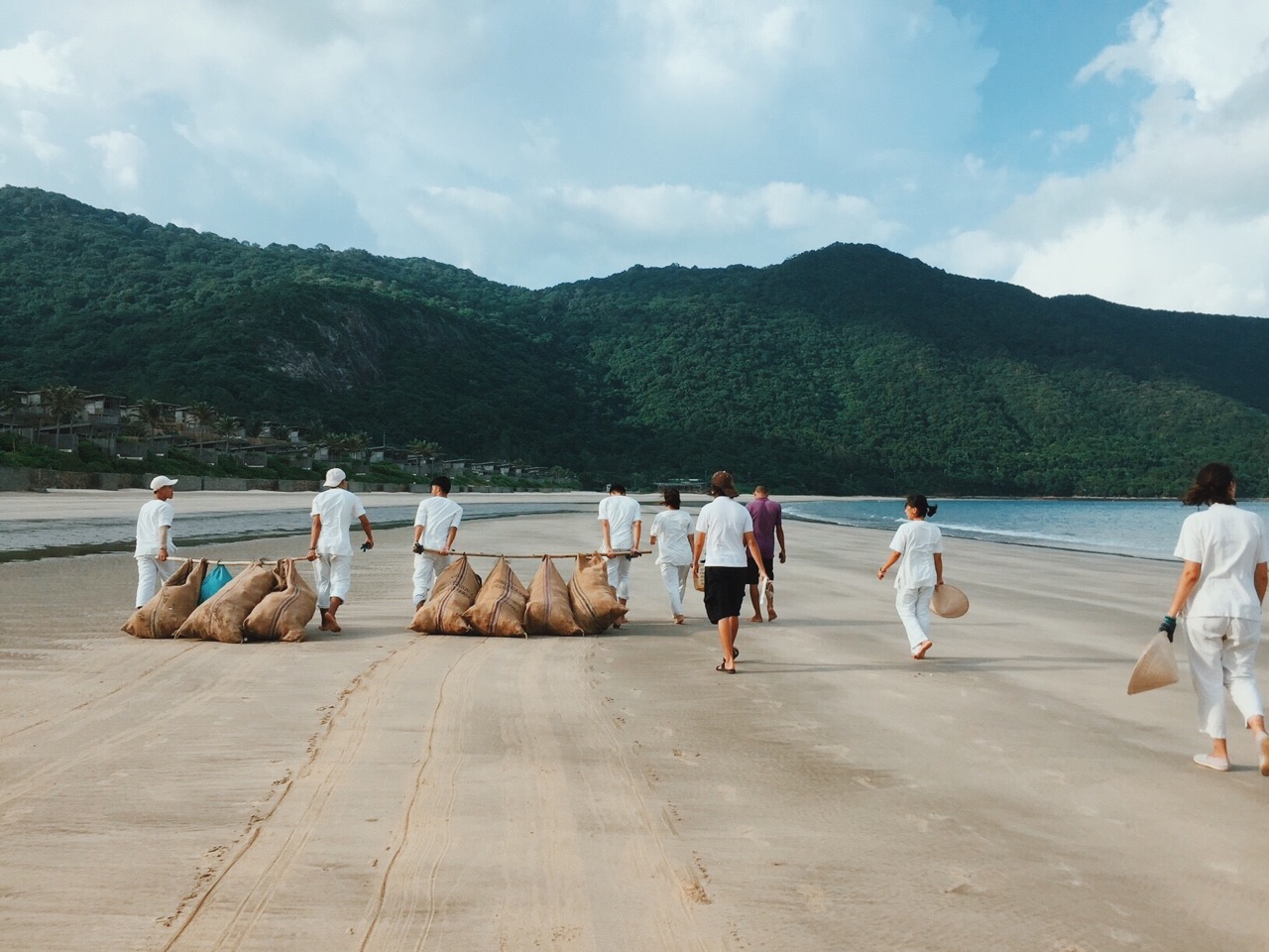 Six Senses Con Dao staff cleaning up the beach