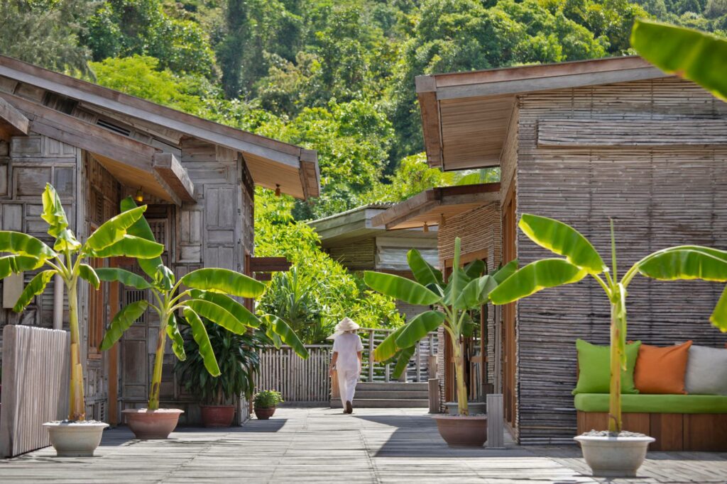 woman walking in between the wooden houses