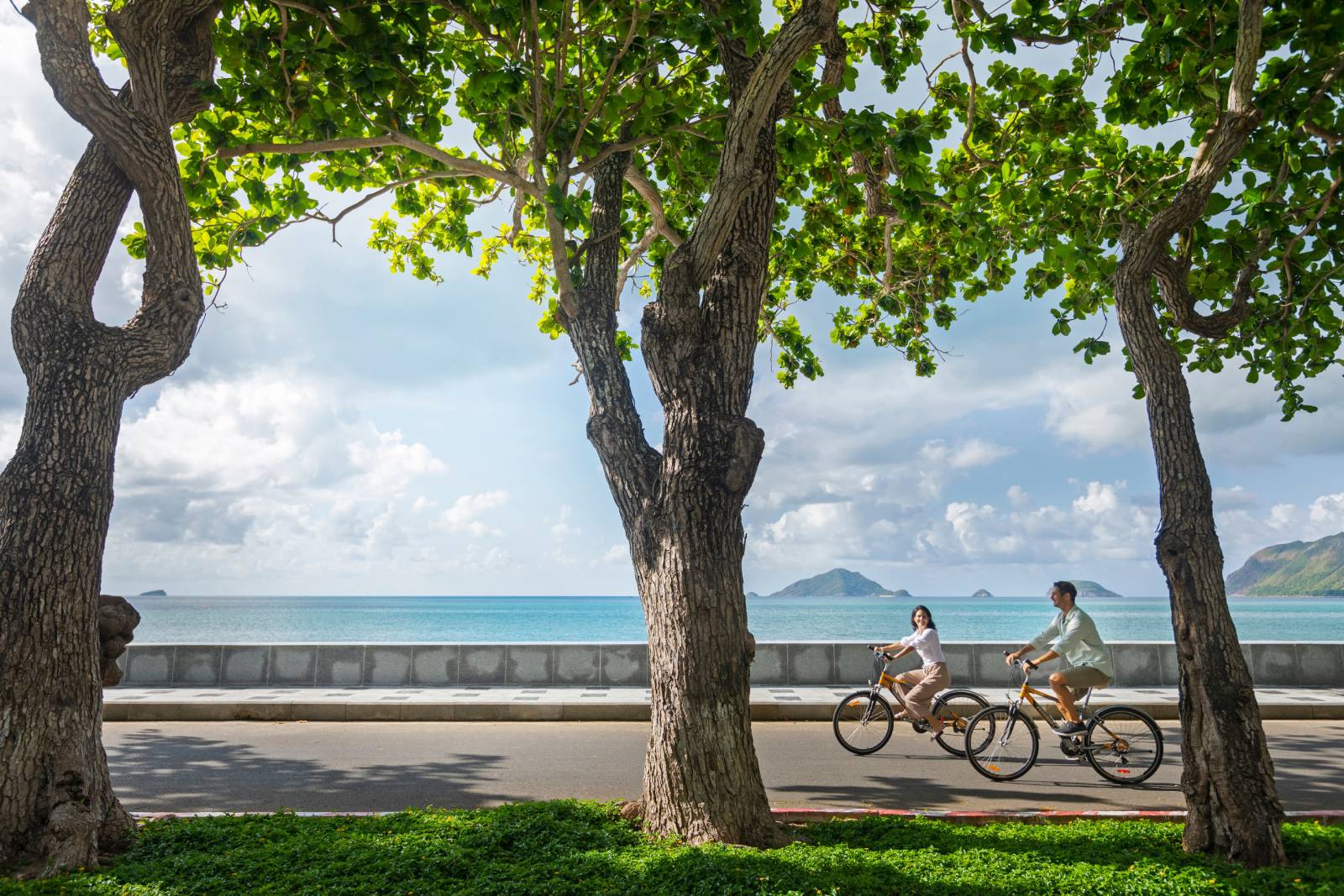 Couple biking along the sea road of Con Dao