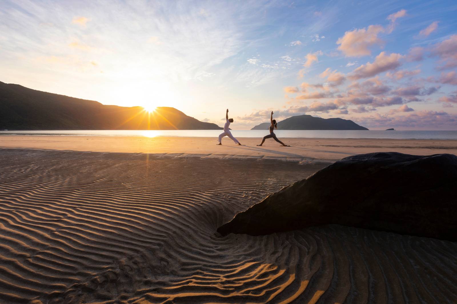 Practicing yoga at sunrise at Six Senses Con Dao