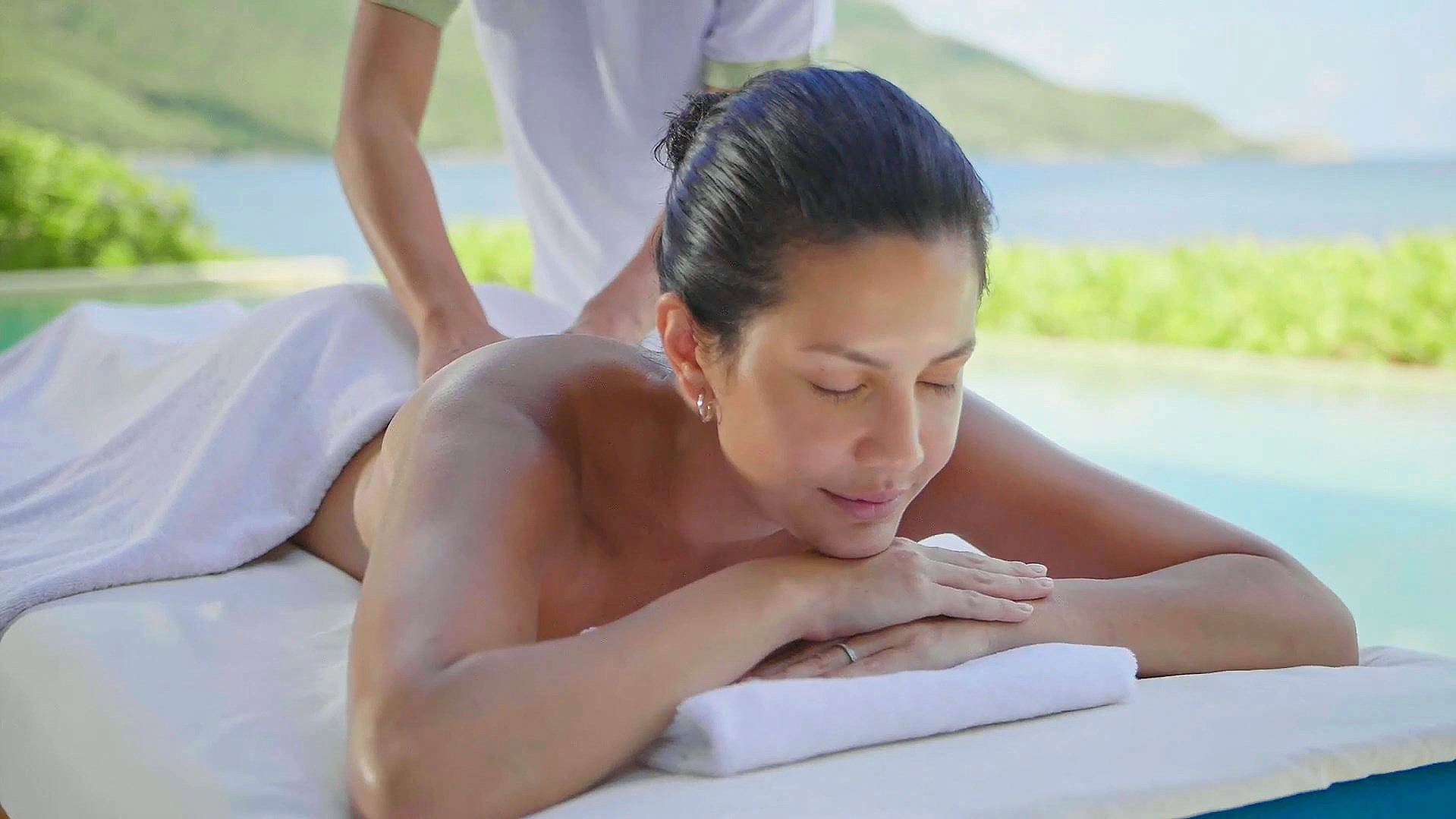 woman enjoying her massage in villa by the pool at Six Senses Con Dao